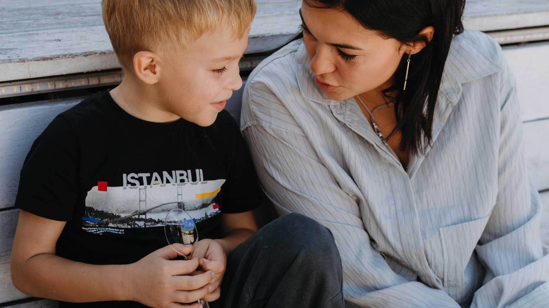 Mother and son sitting together, reflecting calm family communication